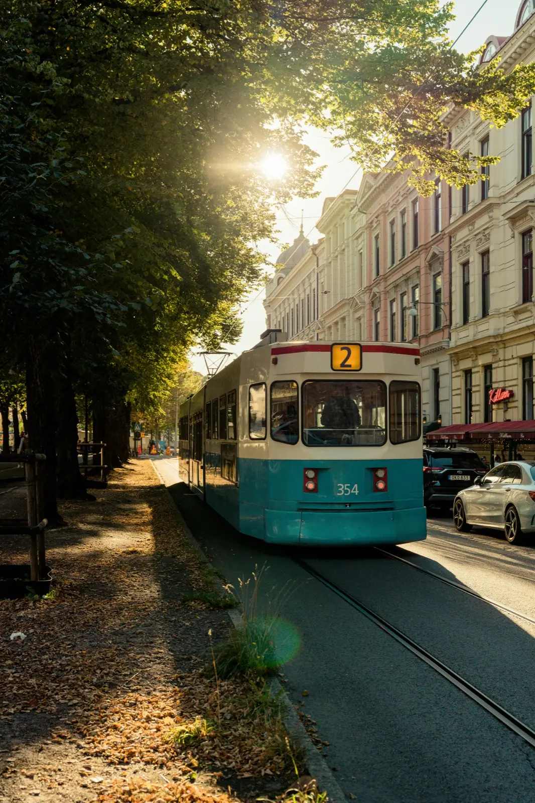 A Gothenburg tram on line 2 in evening sun under the lime trees
