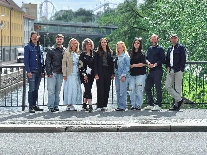 The team behind Tune In West, lined up by a railing in Gothenburg